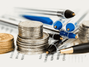 moedas e canetas, representando bancos tradicionais aumentam tarifas bancárias